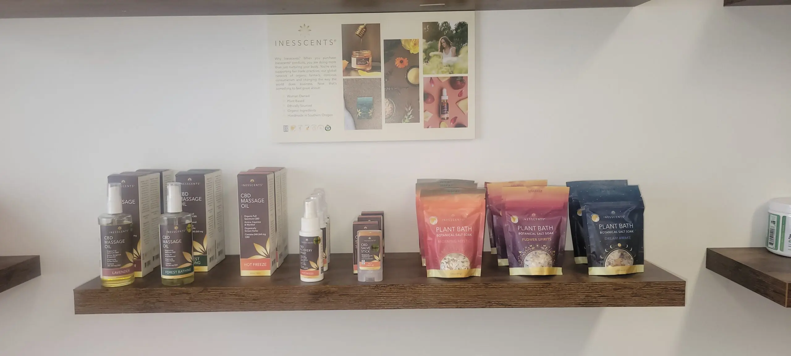 Shelf displaying skincare and wellness products with a motivational poster above.