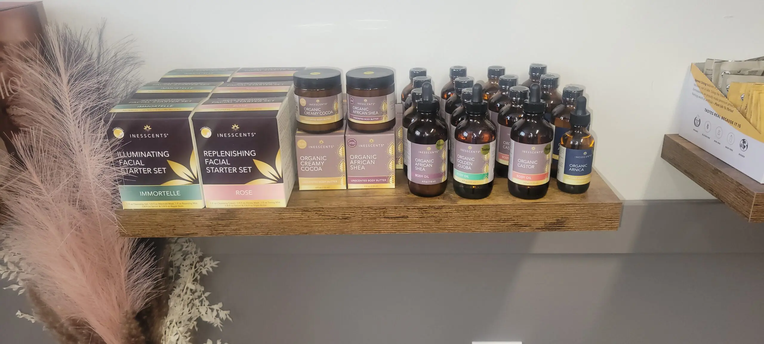 Various skincare products displayed on a wooden shelf.