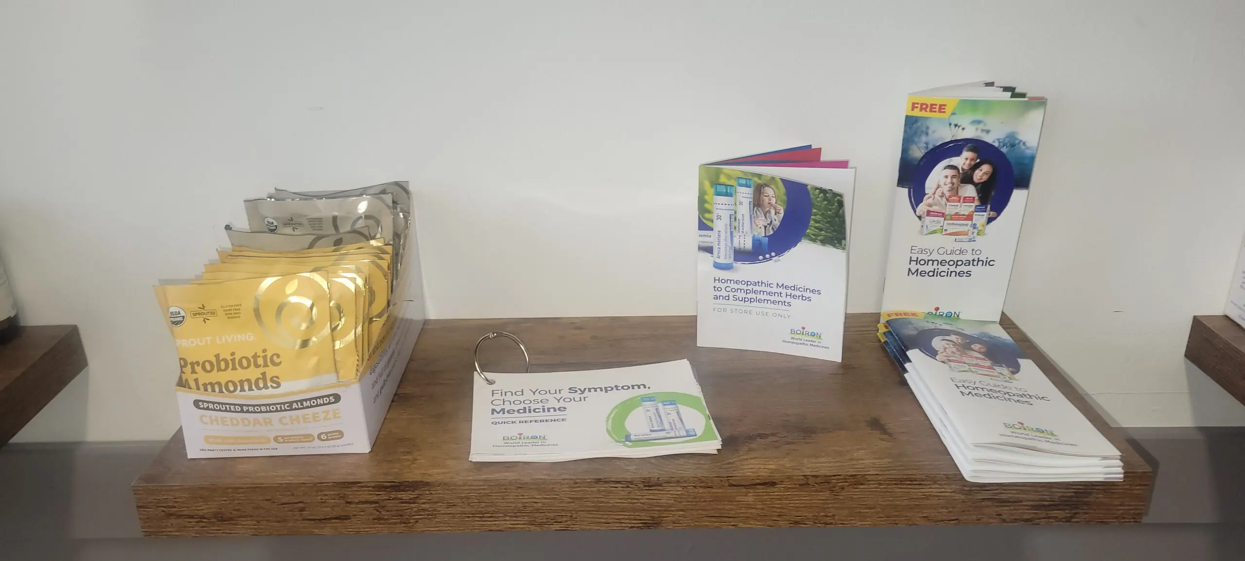 A wooden shelf holding a brochure and a business card about environmental cooperation.