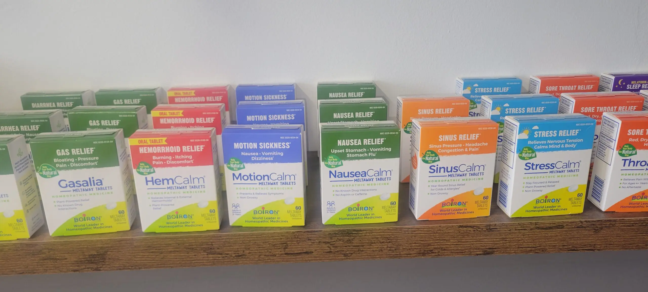 Various boxes of allergy and sinus relief medicines on a shelf.