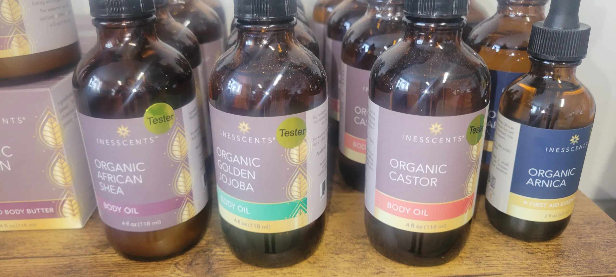 Bottles of organic castor oil on display in amber glass containers.