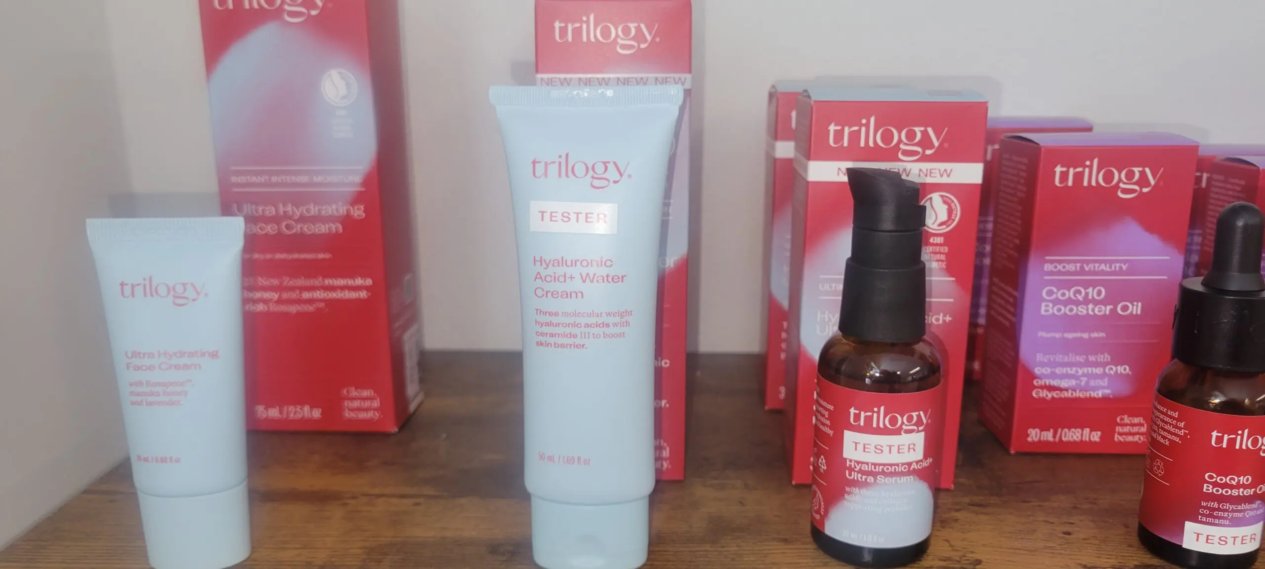 Trilogy skincare products including a cream and serum on display.