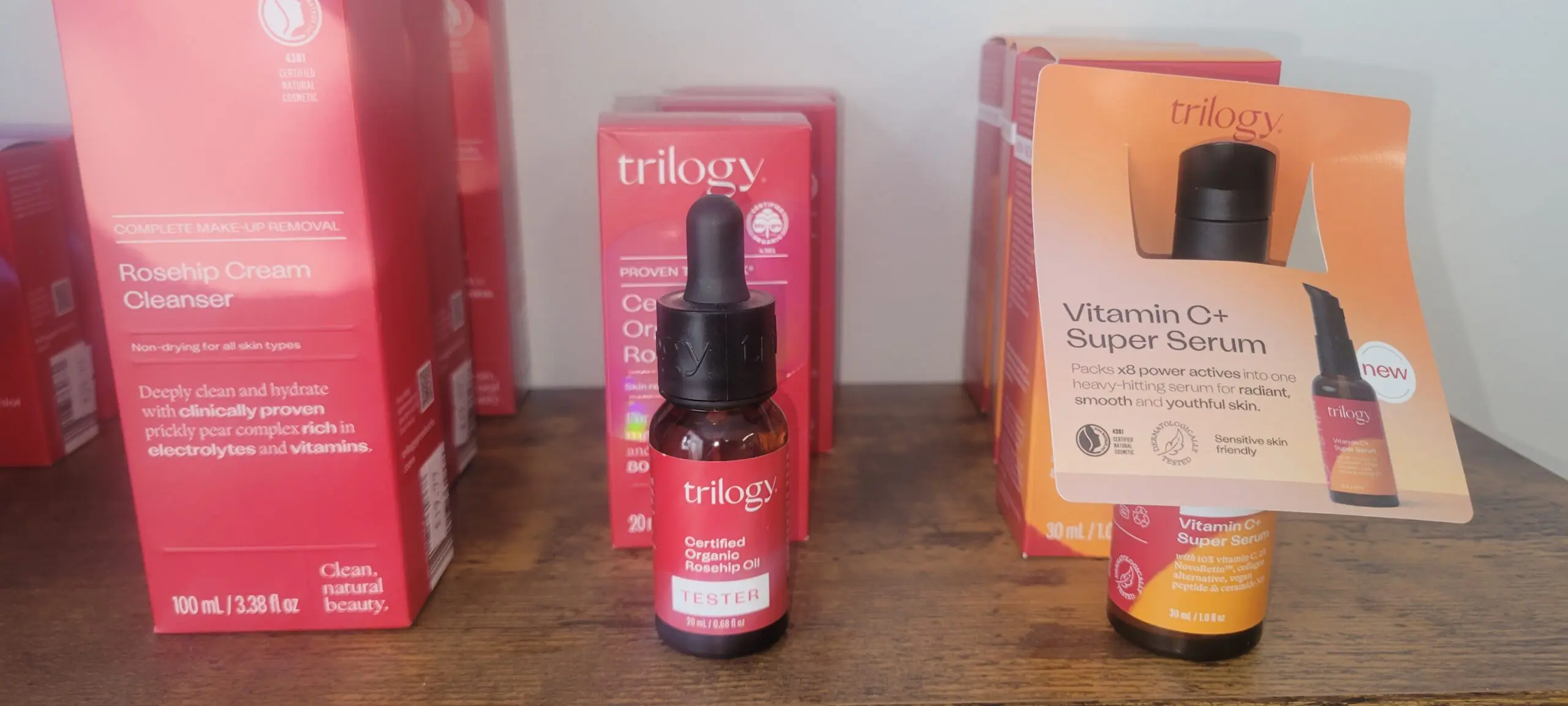 A bottle of Trilogy Certified Organic Rosehip Oil with its box on a shelf.