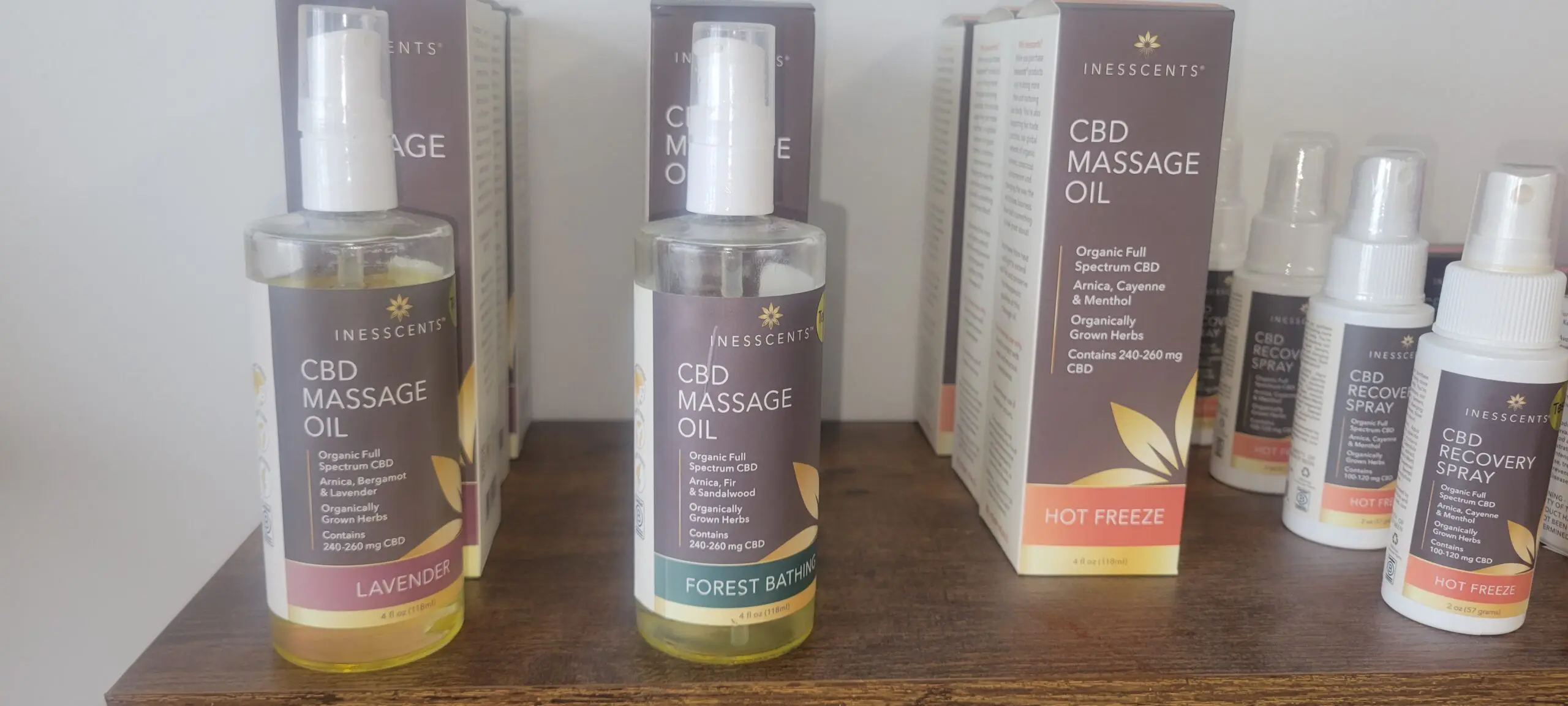 CBD massage oil bottle with natural ingredients on a store shelf.