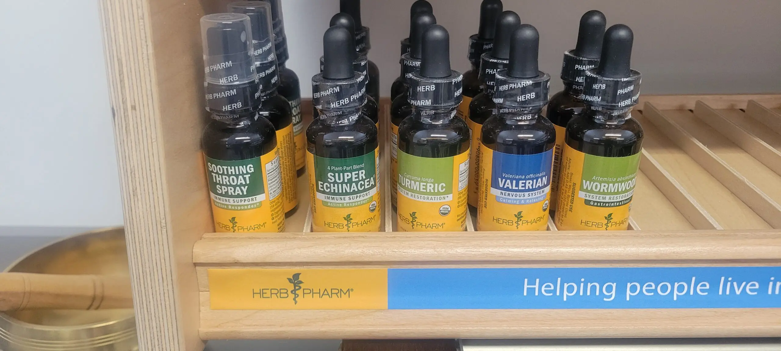 Bottles of herbal extracts labeled with different plant names.