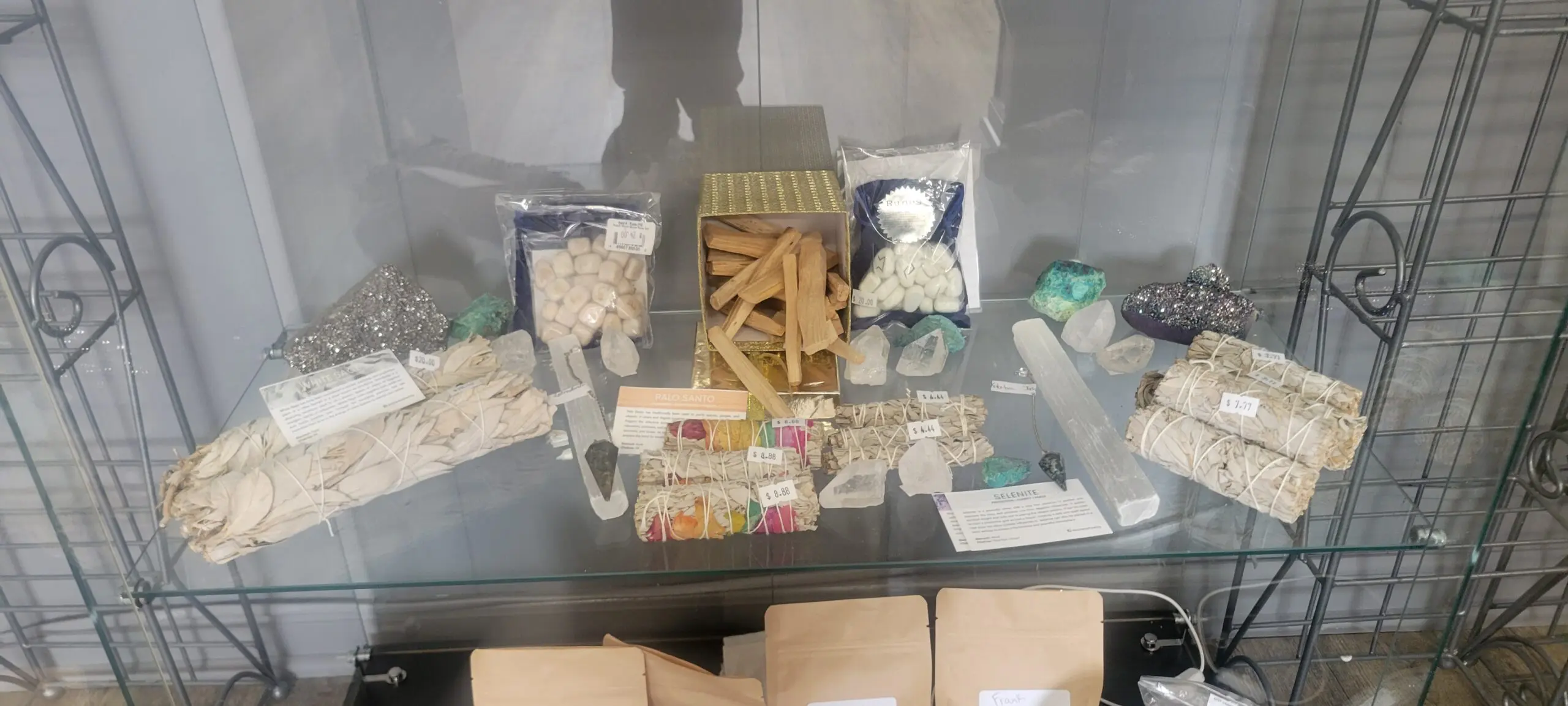 A display of assorted medicinal items and herbal products in jars and pouches.