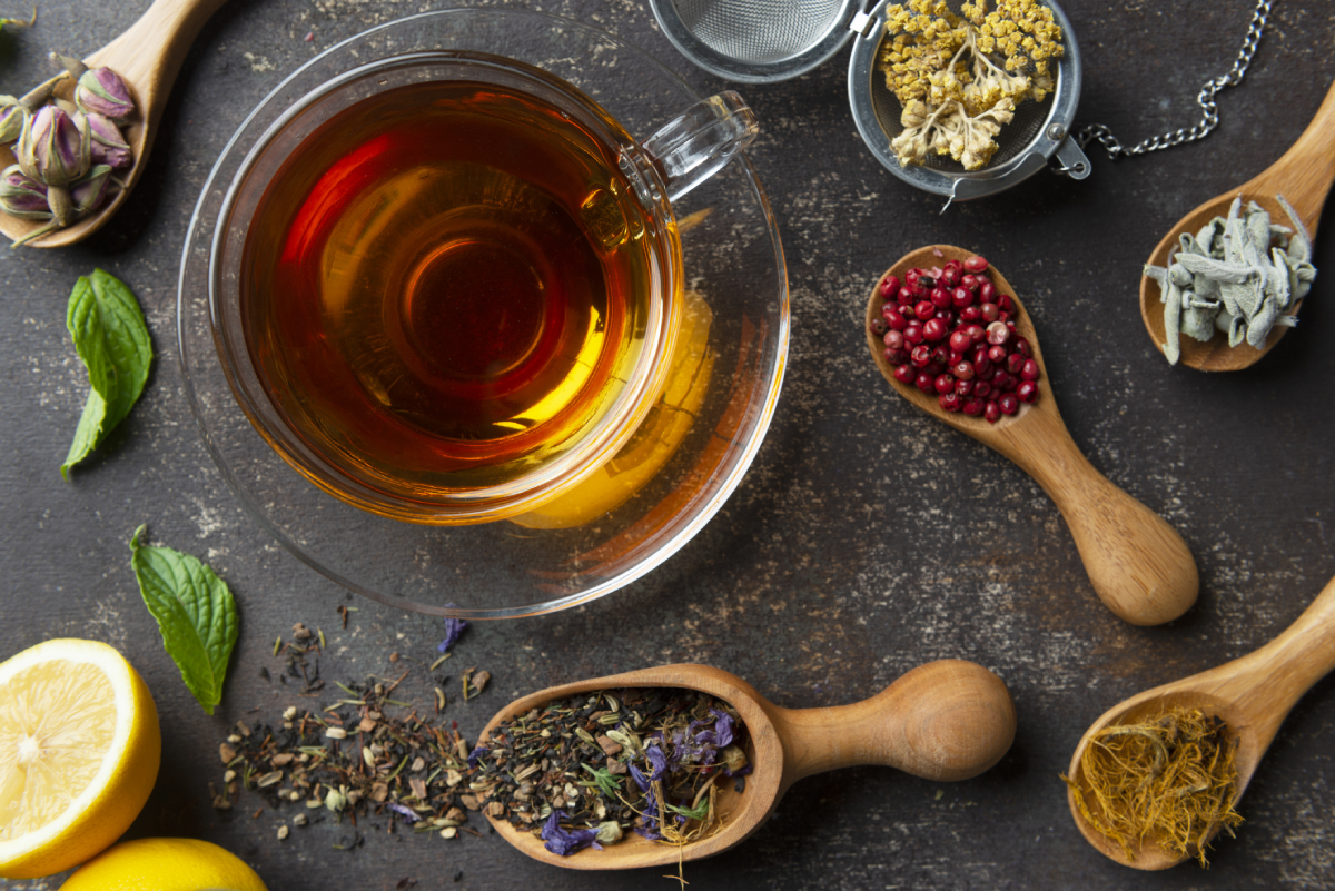 Aromatic herbs and tea displayed on table.
