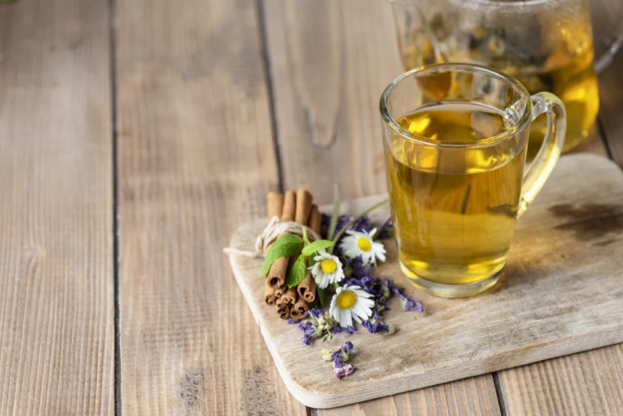 Herbal tea with flowers and cinnamon sticks.